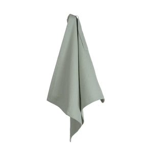 The Organic Company dusty mint Dinner Napkin is shown hanging. Made from 100% GOTS certified organic cotton and woven with a herringbone weave pattern.