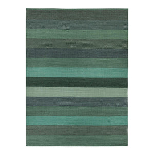 Fabula Living’s Green Veronica Rug has a three dimensional weave pattern which creates varied tonal effect, the rug features different shades of blues and greens in a overall striped block design - by Lisbet Friis