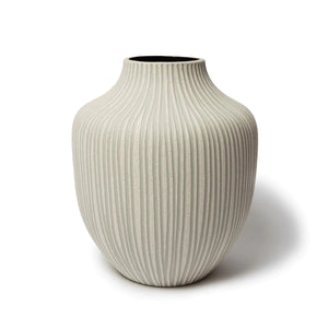 This ceramic vase has a speckled off-white matt finish, with grey lines hand carved into the clay. The vase is glazed on the inside .