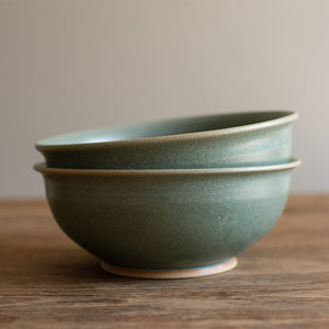 Stack of two lichen glazed stoneware ramen bowls on a wooden surface. Handmade in Britain by Carla Murdoch ceramics.