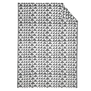 Beatrice Larkin Flint Throw in Merino wool with gentle triangle geometric pattern 