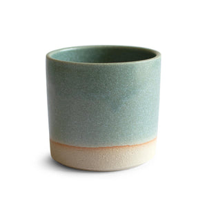 Hand-thrown artisan stoneware tumbler. Ceramic tableware handmade by Carla Murdoch in the UK. The tumbler has an earthy green lichen colour glaze. The lower section of the tumbler outer is left unglazed.