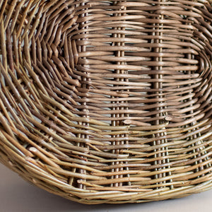Base of a woven willow basket with handle, handmade by Catherine Beaumont basket maker.