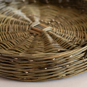 Catherine Beaumont's round Willow Tray is woven in Dicky Meadows with Brittany Green handles and is made with a traditional heritage tied underfoot base. 
