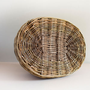 Base of a woven willow basket with handle, handmade by Catherine Beaumont basket maker.