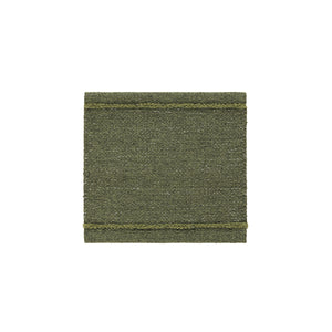 Sample of Kasthall’s Ängsmark Rug, designed by Ilse Crawford. The rug is olive green wool with a lime green stripe, and subtle white flecks running through the weave.