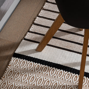 Patterned weave Recork Sugo Maria Rug made from sustainable cork in modern dining room space.