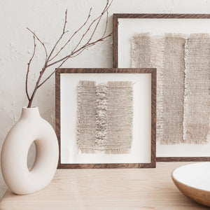 Scandinavian style interior design shelf with neutral woven artworks framed with dark wood. Textile artworks by Woven Form.