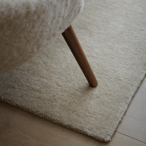 A close up image of Fabula Living’s Beige Ask Rug is hand-loom pile rug in Gabbeh-dyed New Zealand wool and linen on a cotton warp - designed by Jens Landberg Schrøder.