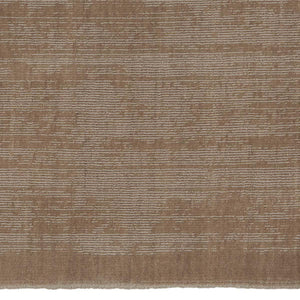 A close up image of  Fabula Living’s Beige Loke Rug, this rug is hand loom woven in a single colour, the technique used soften's the pile and create an irregular pattern designed by Jens Landberg Schrøder