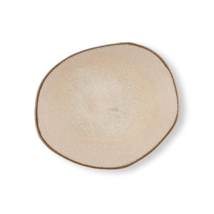 Hana Karim's Beige Mini Plate has an irregular shape and a matt speckled cream-beige glaze.
