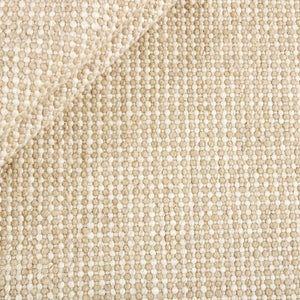 Close up of the Beige Nordic Touch Rug by Rezas is a handwoven kelim. The inviting texture is crafted by weaving together varied yarn weights in beige and cream hues. Natural variations in the yarn tones brings added character to the design.