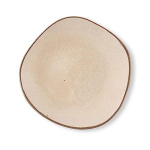 Hana Karim's handmade ceramic Beige Plate has a matt speckled cream-beige glaze and irregular round/oval shape.