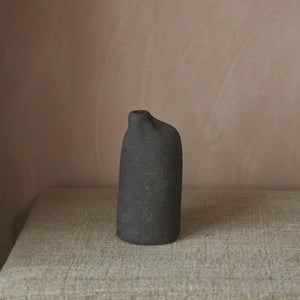 Black Pilgrim Bottle by Be Still ceramics. Stoneware vase with a modern rustic, asymmetric shape and matt charcoal exterior.