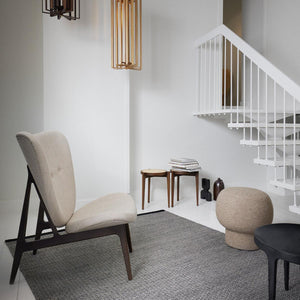 Fabula Living’s Black/Grey Balder Rug has black and grey yarns woven together in this classic goose eye design framed with a dark trim either end. The rug has been placed on the floor of a light coloured room with various furniture framing the rug- designed by Jens Landberg Schrøder.
