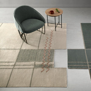 Tacto's Caminos Beige Rug, in a light room with an armchair and side table sat upon the rug - designed by Yonoh