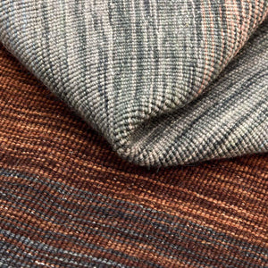A close look at the texture of the Rezas' Brown Panorama Kelim Rug with its handwoven autumnal colour pallet.