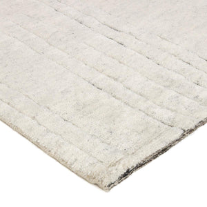 A close up look at Desert Natural Landscape Rug with abstract charcoal lines on a beige knotted rug - by Rezas