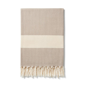 oyster Grey herringbone pattern blanket with contrasting cream band finished with a cream knotted fringe at each end. Ferah organic cotton blanket by Lüks. 