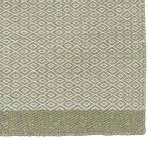 A close up look at Fabula Living’s Forest Balder Rug with forest green hues of wool and linen, hand spun into this classic goose eye design - by Jens Landberg Schrøder.