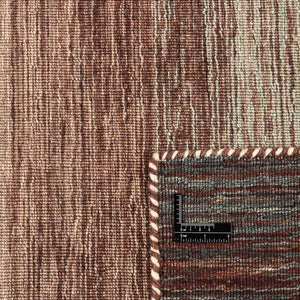 A close look at the texture and colours of the Rezas' Green Panorama Kelim Rug which is gently striped with a colour pattern of warm chestnut browns through to mossy greens and a sandy beige.