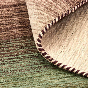 A closer look at the texture of the Green Panorama Rug which features a graduation of harmonious colours from rich, warm chestnut browns through to mossy greens and sandy beige.