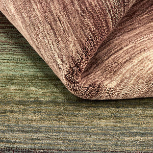 A closer look at the texture of the Green Panorama Rug which features a graduation of harmonious colours from rich, warm chestnut browns through to mossy greens and sandy beige.
