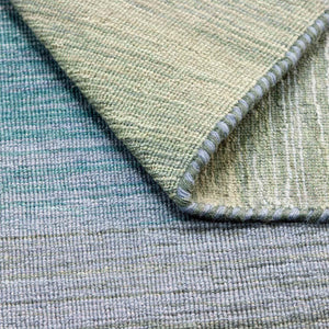 A closer look at the Grey Blue Panorama Kelim Rug with its gentle striped colour pattern that transitions from warm greys and lavenders through to ocean blues and olive greens - by Rezas