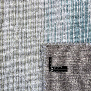 A closer look at the Grey Blue Panorama Kelim Rug with its gentle striped colour pattern that transitions from warm greys and lavenders through to ocean blues and olive greens - by Rezas