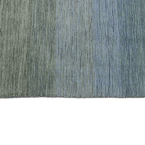 A closer look at the Grey Blue Panorama Rug with its gentle striped colour pattern that transitions from warm greys and lavenders through to ocean blues and olive greens - by Rezas