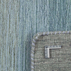 A closer look at the Grey Blue Panorama Rug with its gentle striped colour pattern that transitions from warm greys and lavenders through to ocean blues and olive greens - by Rezas