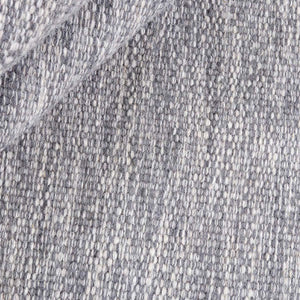 A close look at the weave pattern and texture of the Rezas' Grey Comfort Rug which has a two tone weave effect. The rug is finished with a simple striped border at the ends.