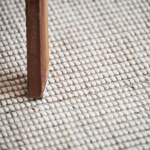 Grey white Nordic Flair Rug by Rezas with a textured and chunky weave in neutral tones.