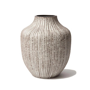 This handmade ceramic vase has a speckled brown texture with a linear grey pattern carved into the clay.