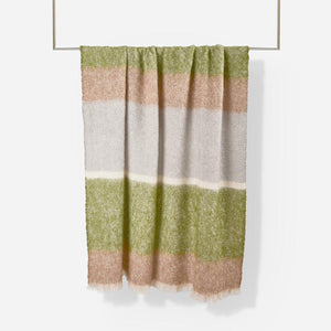Rowan Silare mohair throw blanket by Cushendale, features block stripes of green, warm brown and grey, shown hung on rail.